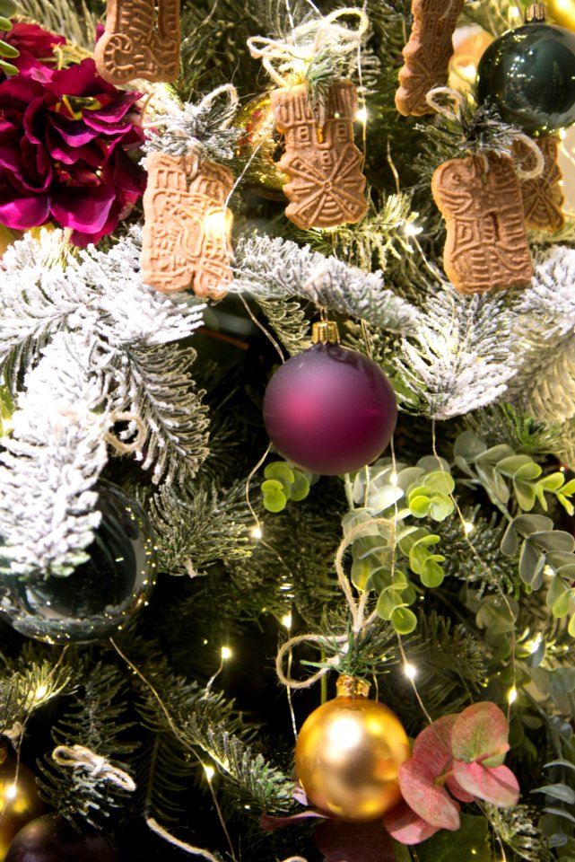 Green Christmas Tree Filled With Decors And Bauble photo