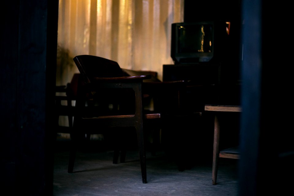 Brown Wooden Chair And Gray Crt Tv
