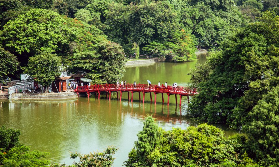 Aerial Photography Of People Crossing Bridge Over Body Of Water