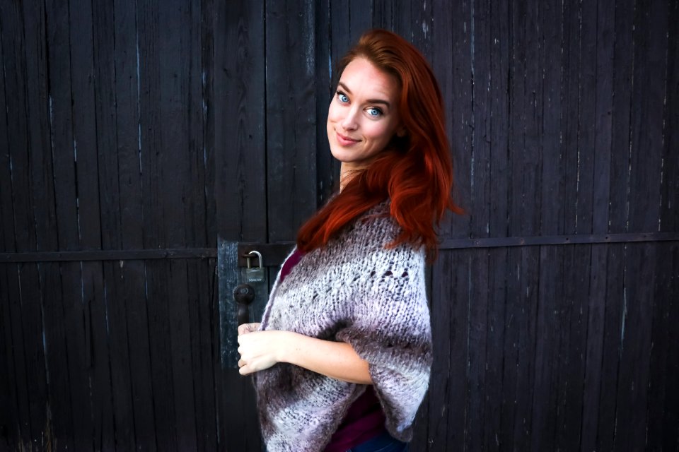 Woman Wearing Grey Printed Poncho Posing For Photo