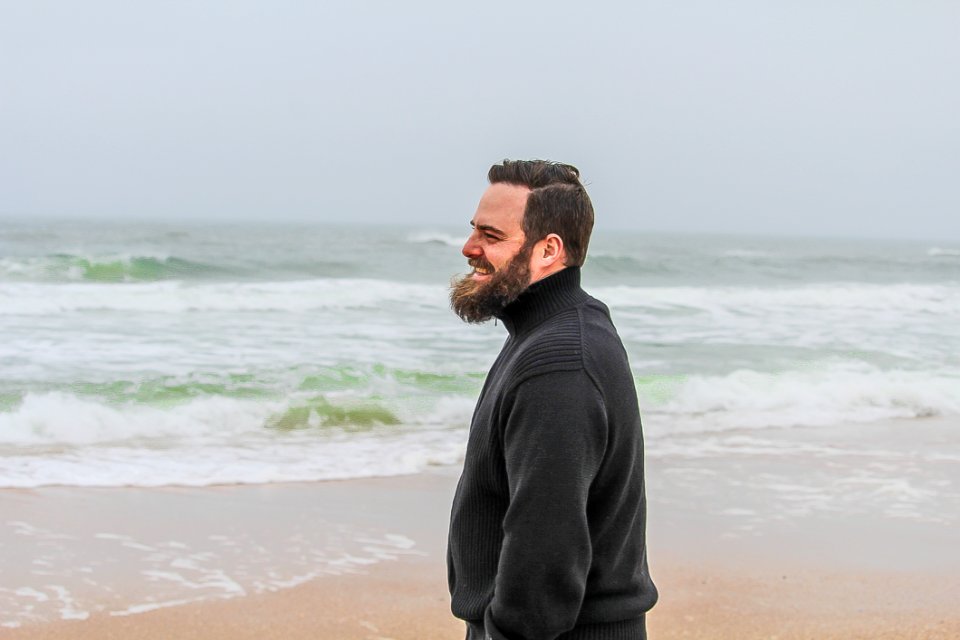 Man In Black Turtle-neck Jacket Standing On Shore photo