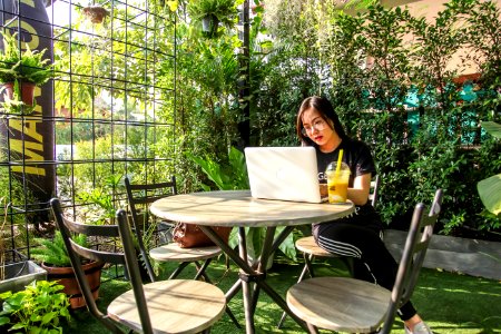 Woman Sitting On Chair While Using Laptop photo