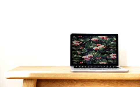 Macbook Pro On Top Of Brown Desk photo