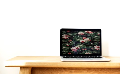 Macbook Pro On Top Of Brown Desk