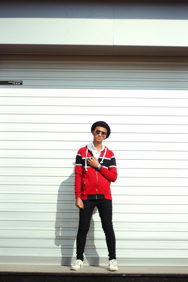 Man In Red And Black Zip-up Jacket And Black Pants With Black Hat photo