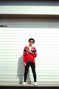 Man In Red And Black Zip-up Jacket And Black Pants With Black Hat