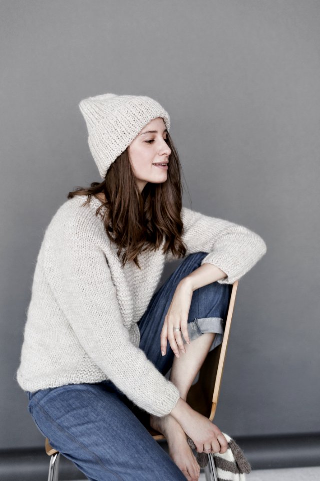 Woman In White Sweater And Beanie With Blue Denim Pants photo