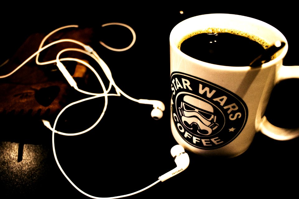 Star Wars Ceramic Mug Filled With Black Liquid With White Canal Buds Beside It