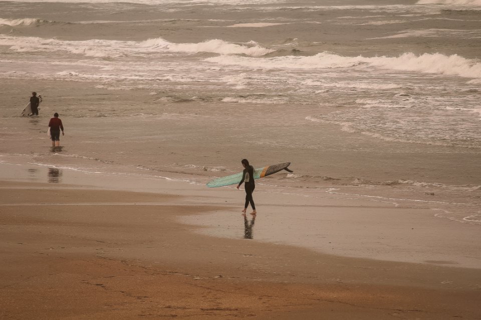 Person Holding Of Green Surfing Board Near Lake