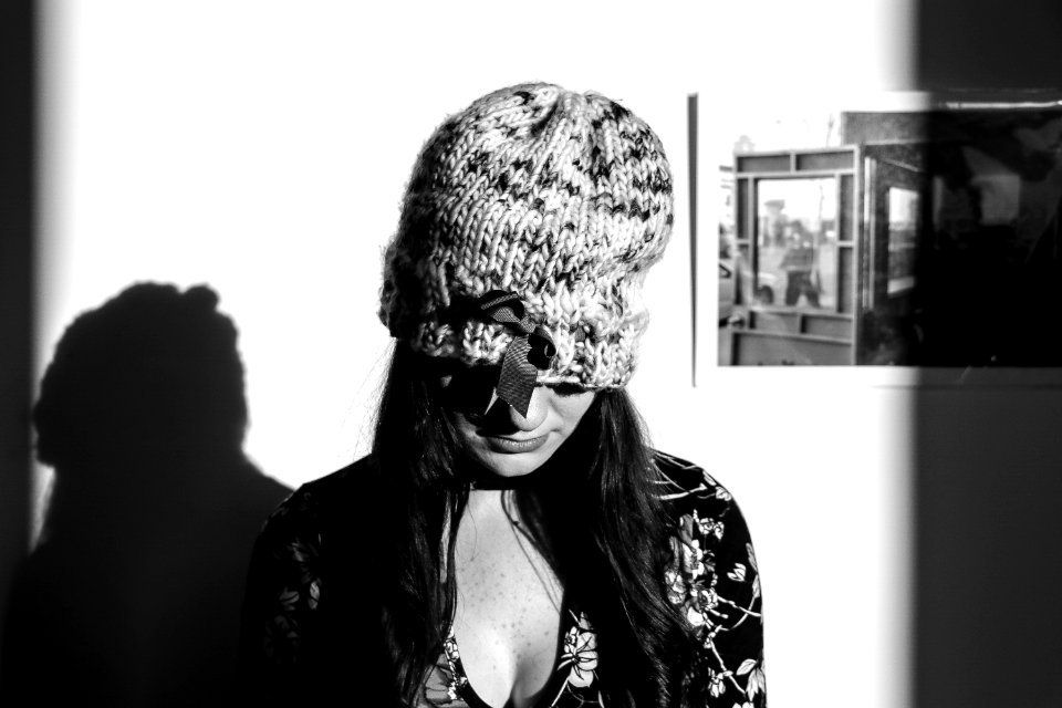 Greyscale Photo Of Woman Wearing Knitted Hat And Floral Long-sleeved Top photo