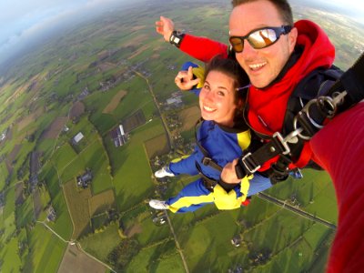 Woman And Man Wearing Overalls Sky Diving