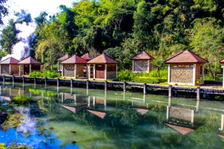 Kiosks Near Calm Body Of Water Surrounded By Tall Trees At Daytime photo