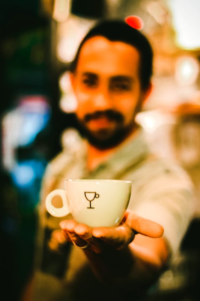 Focus Photography Of Man Holding Ceramic Teacup