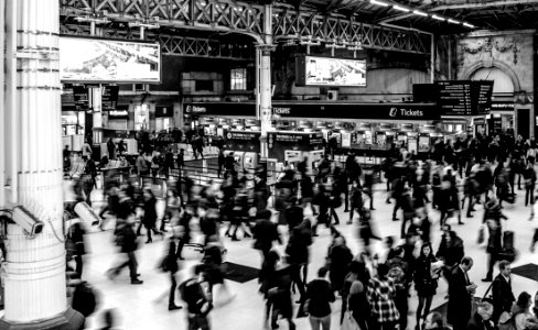 Grayscale Photography Of People Walking In Train Station photo