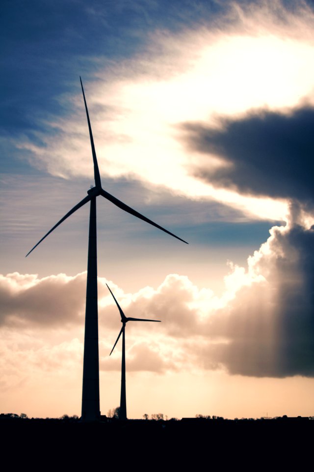 Silhouette Photo Of Two Wind Mills During Golden Hour photo