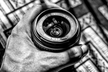 Grayscale Photography Of Person Holding Dslr Zoom Lens photo