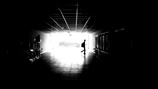 Silhouette Of Man Walking On Hall photo