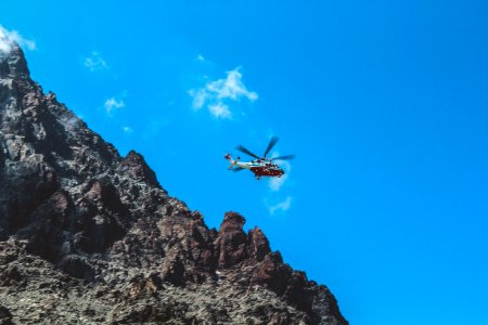 Photography Of White And Red Helicopter Flying
