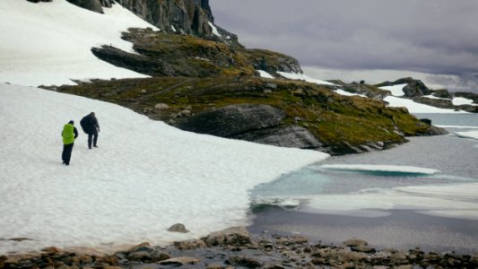 Photography Of People Walking Near Body Of Water photo