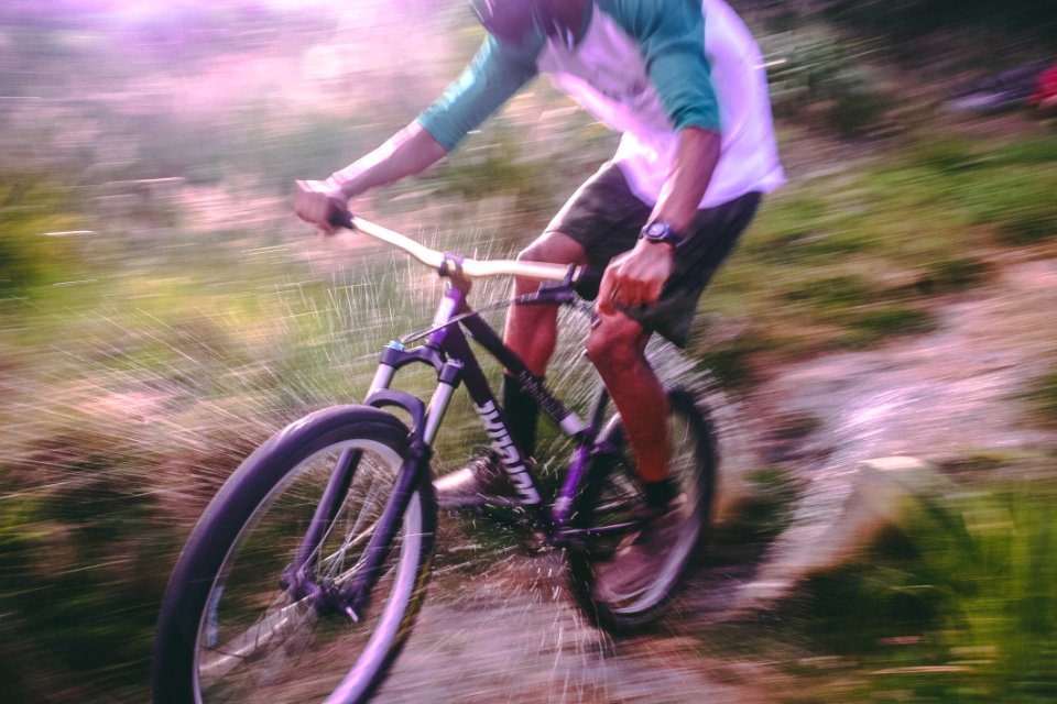 Man Riding Black And White Hardtail Mountain Bike photo