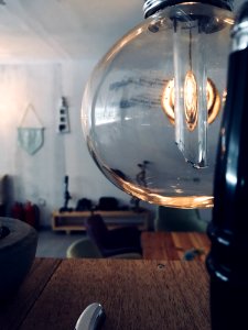 Clear Glass Lamp Near Brown Wooden Surface photo