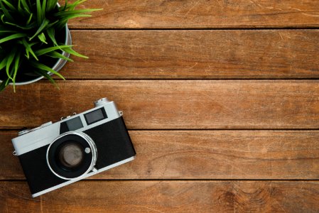 Black And Silver Film Camera On Brown Wooden Surface photo