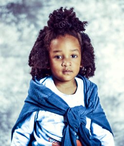 Photo Of Kid With Blue Scarf And White Long-sleeve Top photo