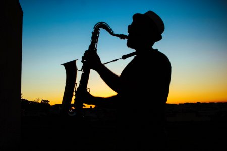 Silhouette Of A Man Playing Saxophone During Sunset photo