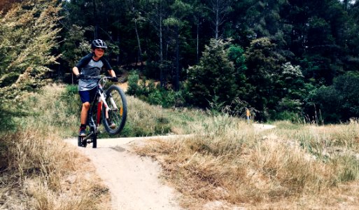 Photo Of Boy Riding A Bike photo