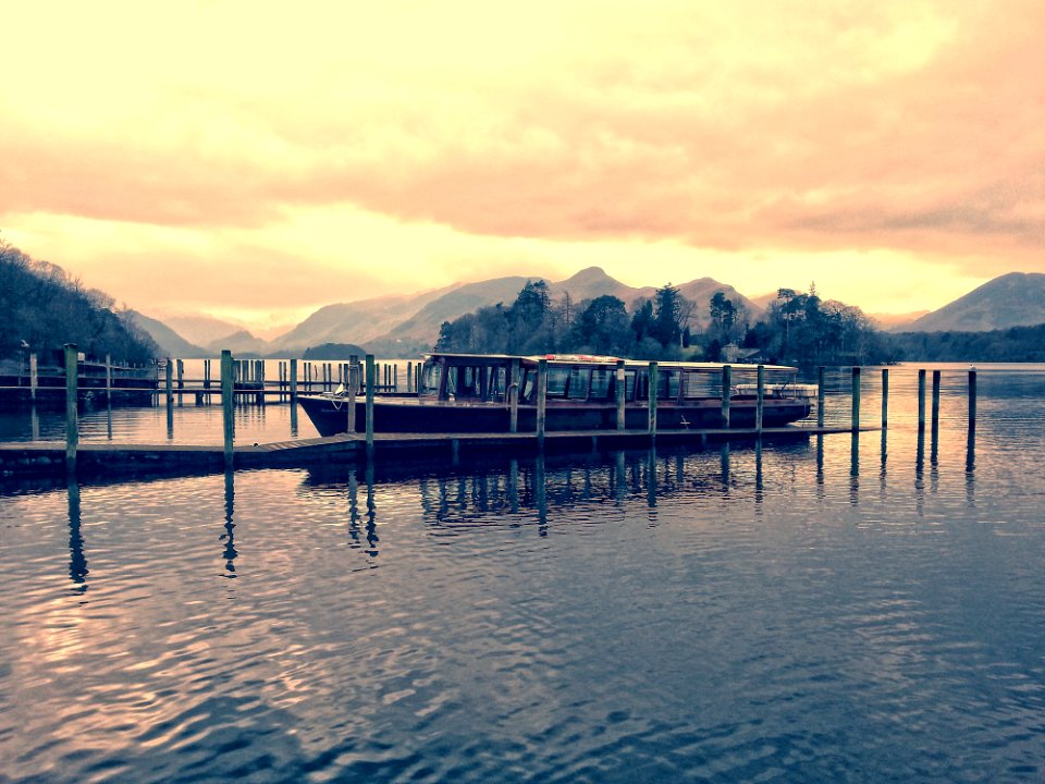 Boat Beside Dock During Golden Hour