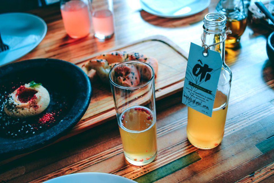 Clear Glass Bottle And Drinking Glass With Brown Liquid photo