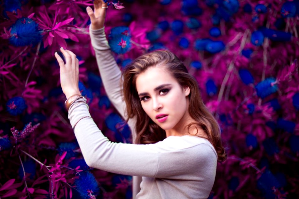 Woman Holding Purple And Blue Flowers
