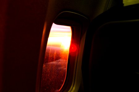 Photography Of Airplane Window During Dusk photo