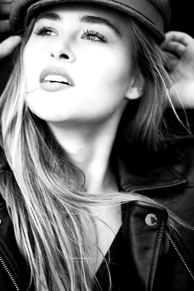 Grayscale Photography Of Woman Wears Leather Jacket And Cap photo