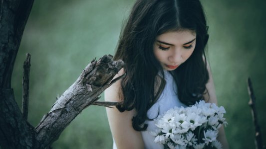 Woman Wearing White Halter Top Holding White Flower Bouquet photo