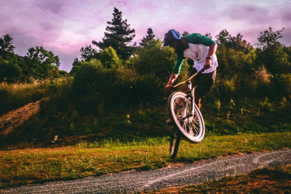 Man In White And Green Raglan Elbow-sleeved Shirt Biking At Daytime
