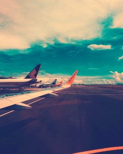 Plane On Airport Under Cloudy Sky At Daytime photo