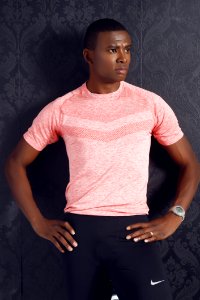 Man Wearing Pink Crewneck Shirt And Black Nike Shorts Standing photo