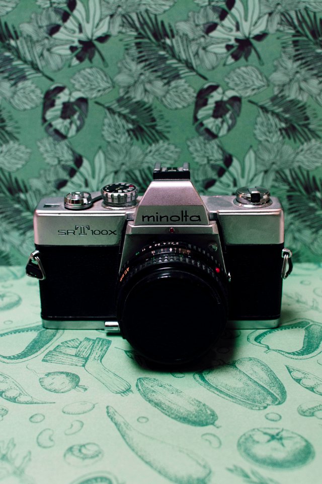 Black And Gray Film Camera On Green Floral Textile