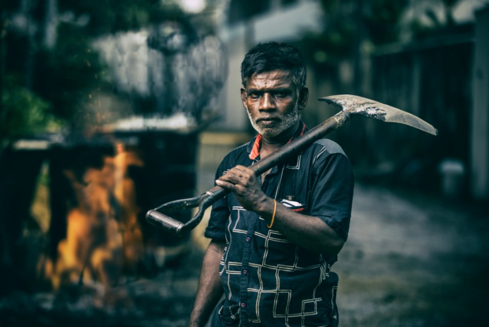 Depth Of Field Photography Of Man In Black Shirt Holding Shovel