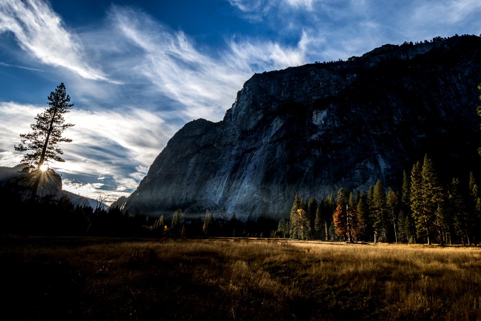 Photo Of Mountain And Trees Under Cloudy Skies