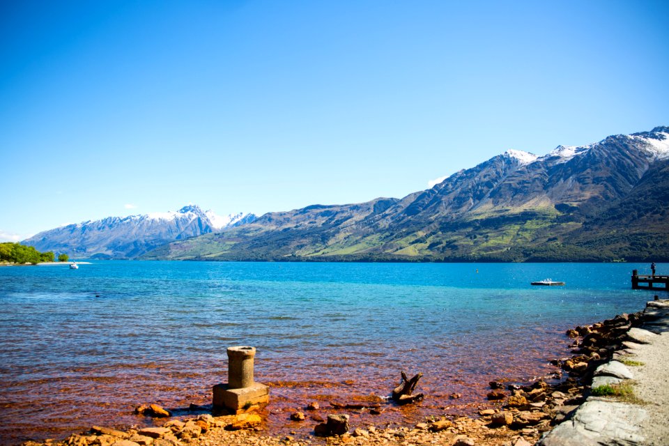 Wooden Dock On Body Of Water Near Green Mountain