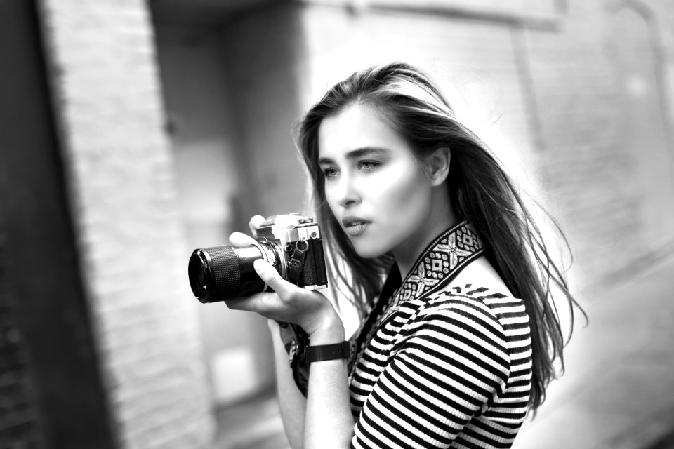 Grayscale Photo Of Woman Holding A Dslr Camera