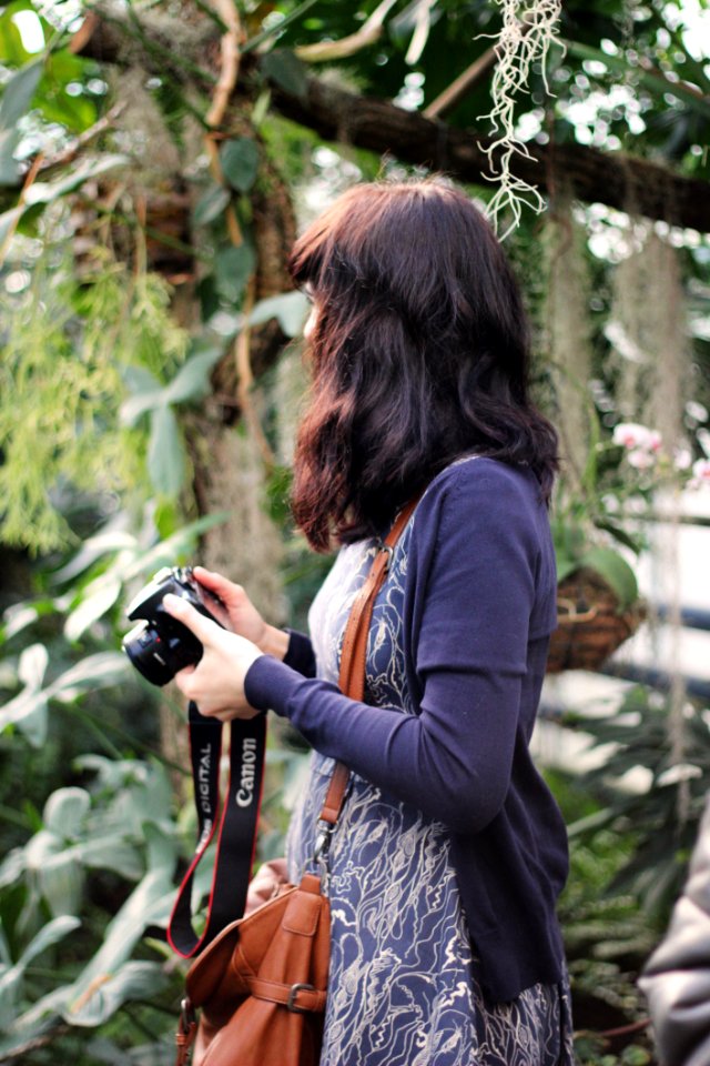 Woman In Blue Cardigan Holding Canon Dslr Camera