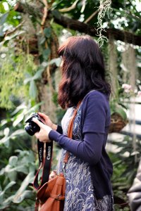 Woman In Blue Cardigan Holding Canon Dslr Camera photo
