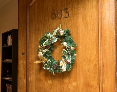 Christmas Wreath Hanging On Brown Wooden Door Of Room 803 photo