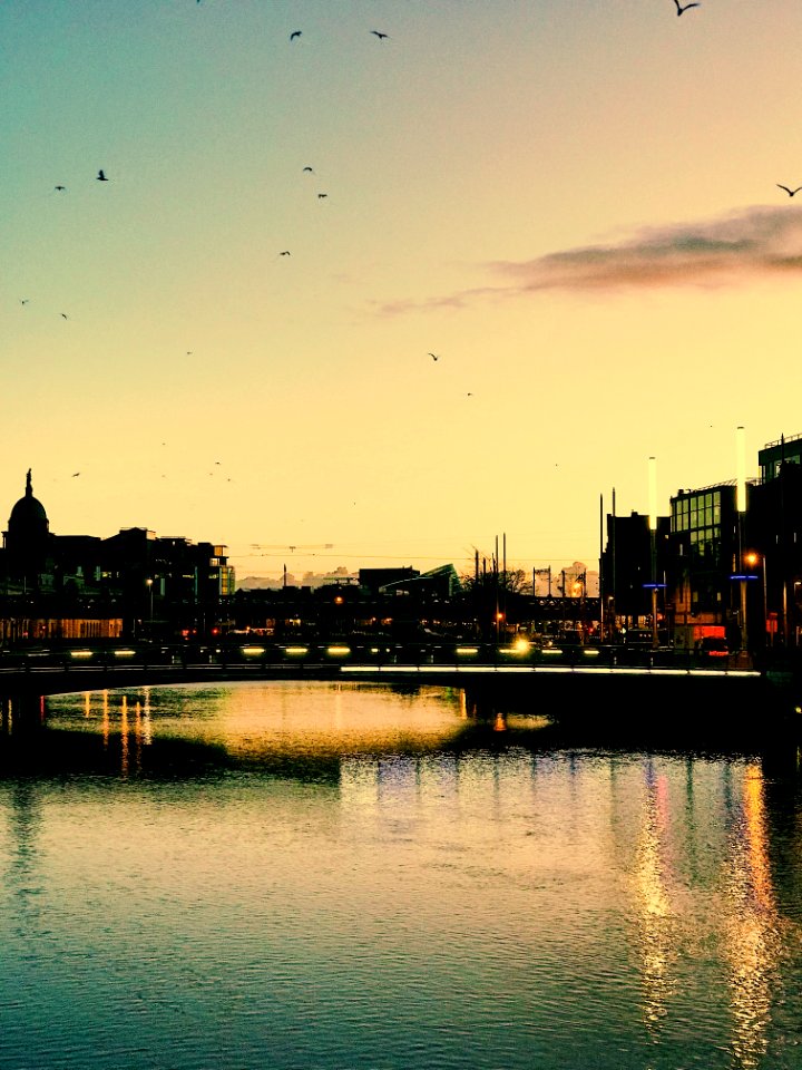 Photography Of Building Beside Body Of Water During Sunset photo