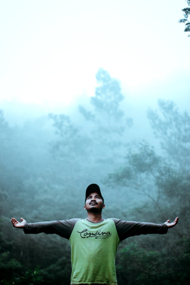 Man Wearing Black And Green Long Sleeve Shirt And Cap