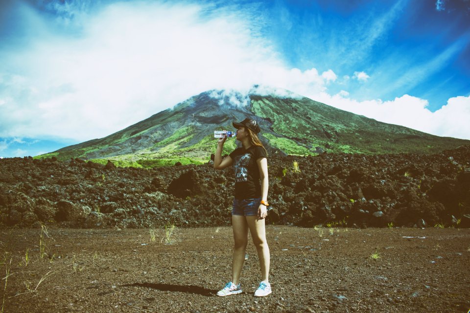 Woman Drinking Water Beside Mountain photo