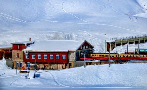 Yellow And Red Train Beside Snowy Mountain photo